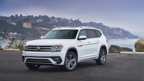 A white 2020 Volkswagen Atlas parked near water.