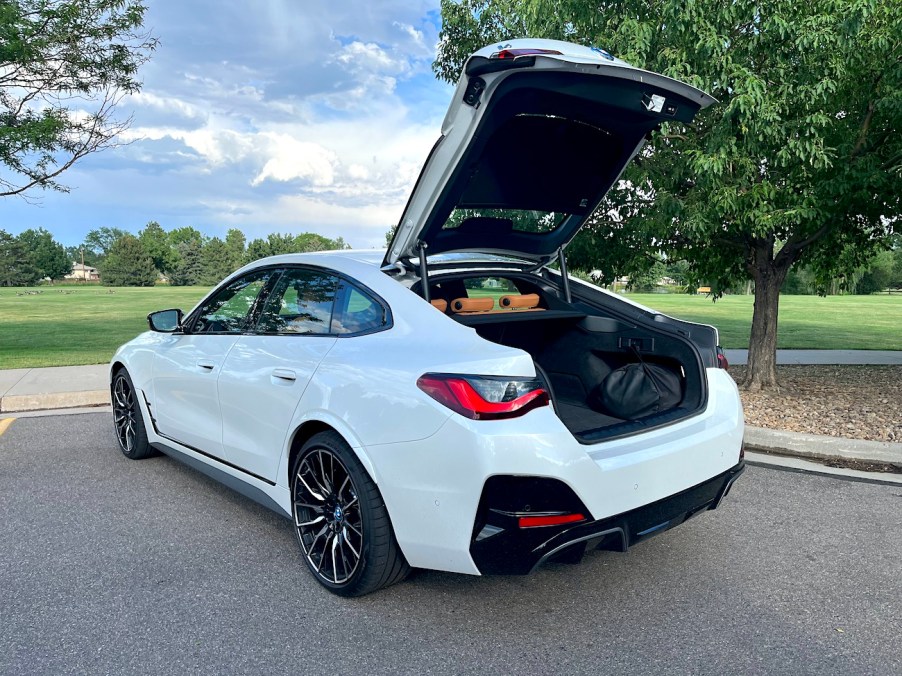 A rear view of the 2022 BMW i4 M50 with the trunk open.