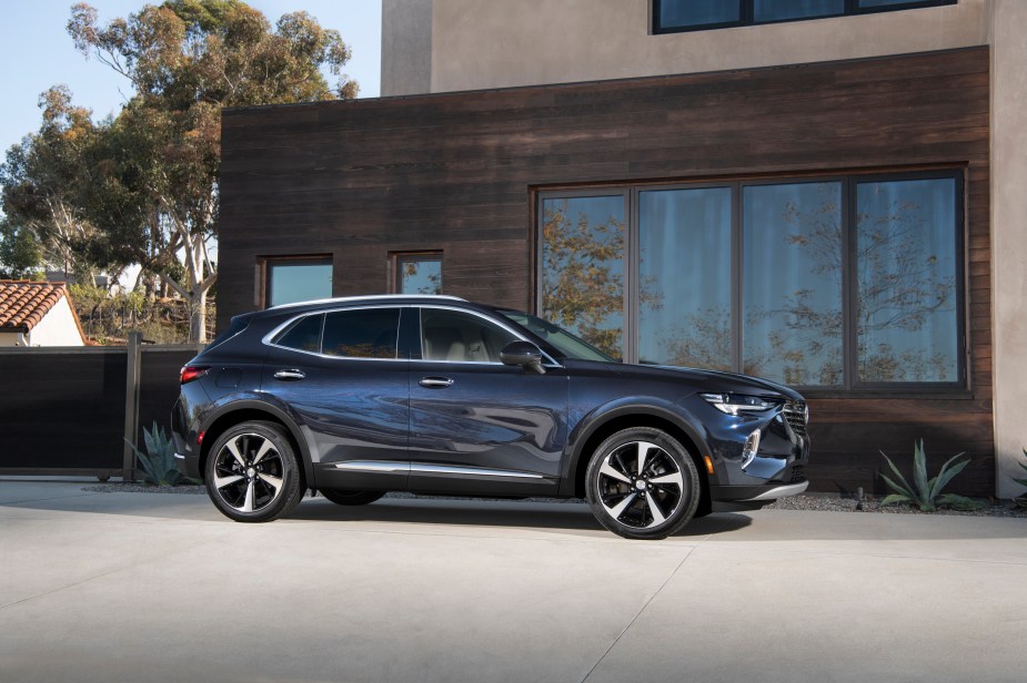 2022 Buick Envision in front of a mid-century modern house. General Motors brands are forcing buyers into an optional OnStar subscription. 