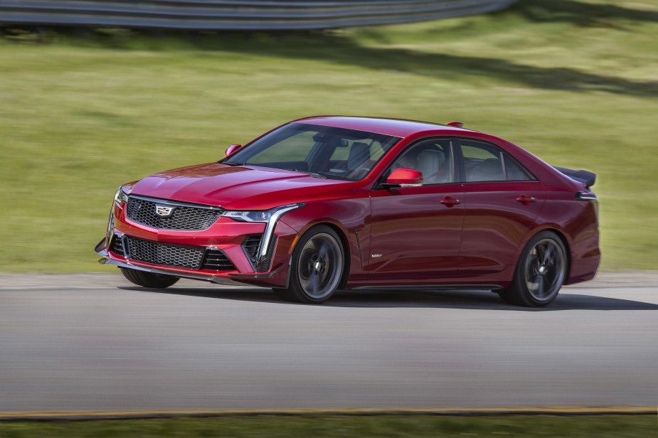 A red 2022 Cadillac CT4-V Blackwing with Carbon Fiber packages racing on a racetrack