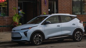 The front 3/4 view of a light-blue 2022 Chevrolet Bolt EUV Premier on a Chicago city street