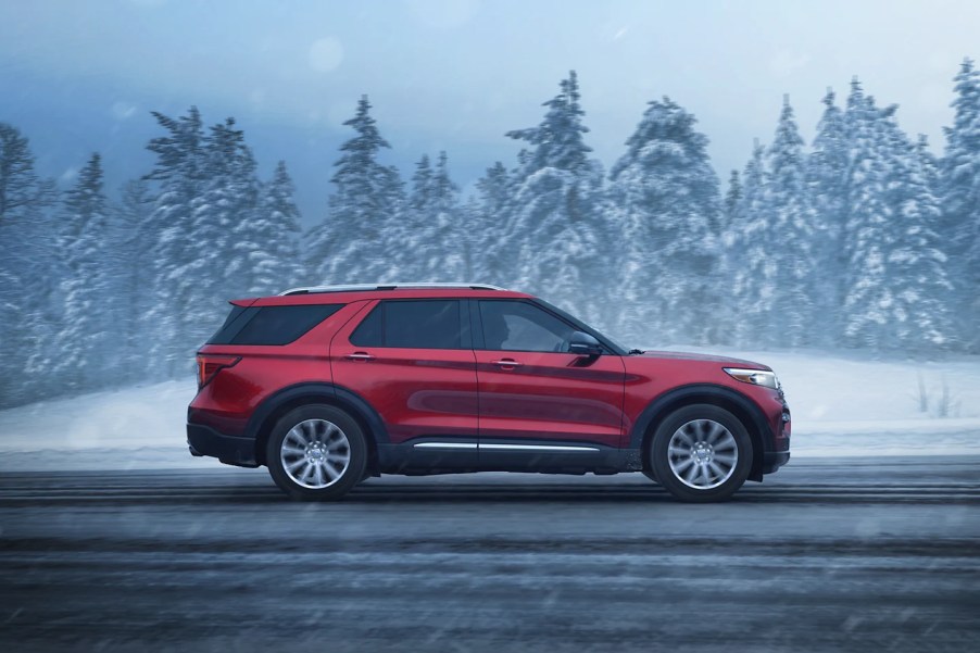 A red 2022 Ford Explorer midsize SUV. Is the most popular trim XLT or experts favorite Limited better?