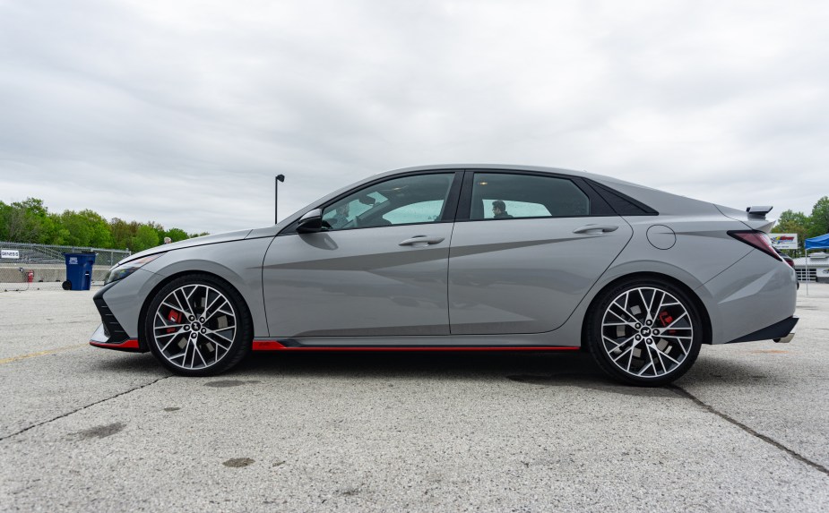 The side view of a gray 2022 Hyundai Elantra N DCT in Road America's parking lot