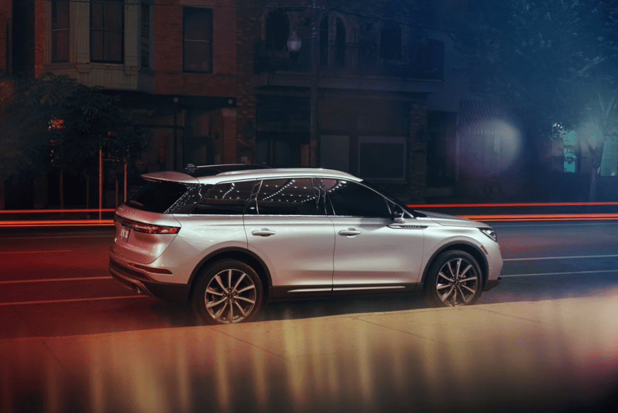 A side shot of a silver gray 2022 Lincoln Corsair luxury compact SUV parked on the side of a street