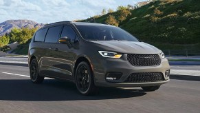 A taupe-colored 2022 Chrysler Pacifica with mountains in the background.