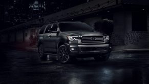 A 2022 Toyota Sequoia in dark grey parked outside in a dark outdoor area.