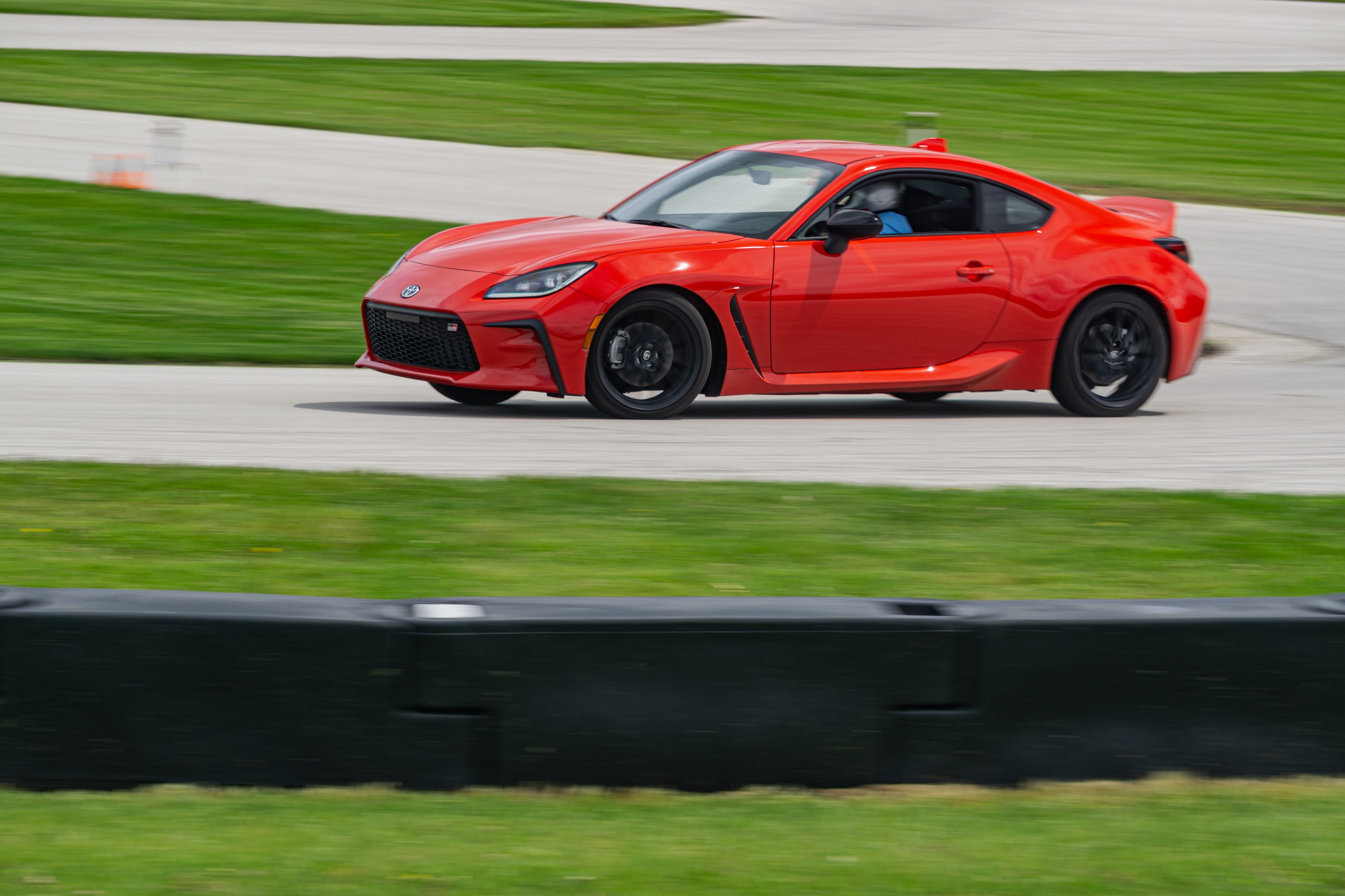 A red 2022 Toyota GR86 Premium cornering around Road America's autocross course