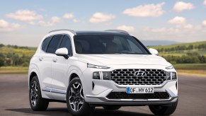 A white Hyundai Santa Fe parked outdoors.