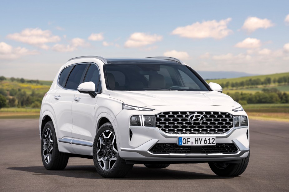   A white Hyundai Santa Fe parked outdoors. 