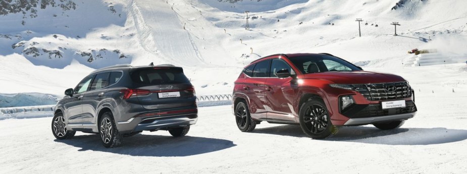  a pair of Hyundai Santa Fe SUVs in snow. 