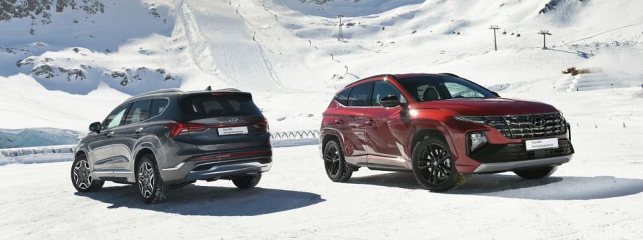 two 2022 Hyundai Santa Fe SUVs in the snow