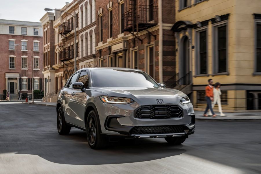 A gray 2023 Honda HR-V Sport subcompact SUV model driving through a city