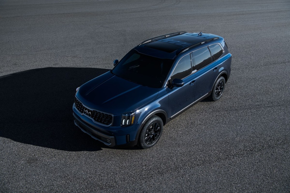 A blue Kia Telluride in a parking lot. 