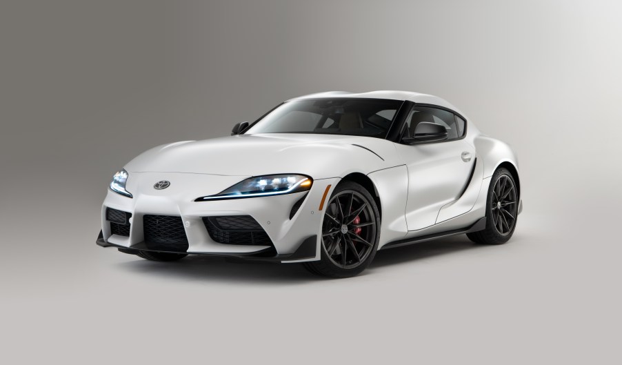 A white 2023 Toyota GR Supra MT 3.0 in a gray studio