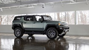 2024 GMC Hummmer EV in green in a showroom