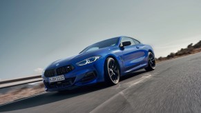 A blue BMW M850i xDrive Coupé on the highway