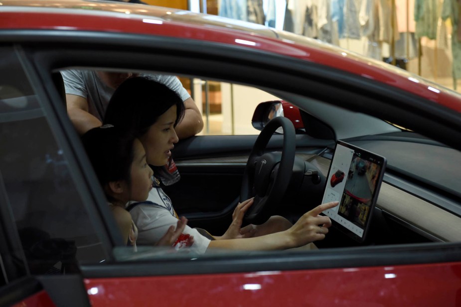 A person in a car potentially before buying a new car. 