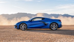 A blue Corvette Stingray parked in sand, the Corvette is among the most affordable supercars