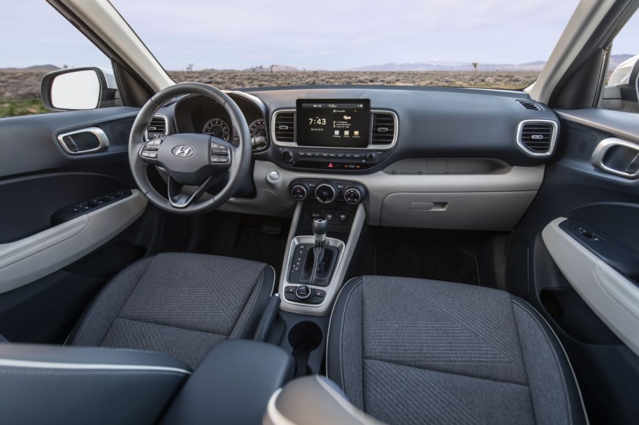 Dashboard and front seats in dark gray 2023 Hyundai Venue, highlighting its release date and price