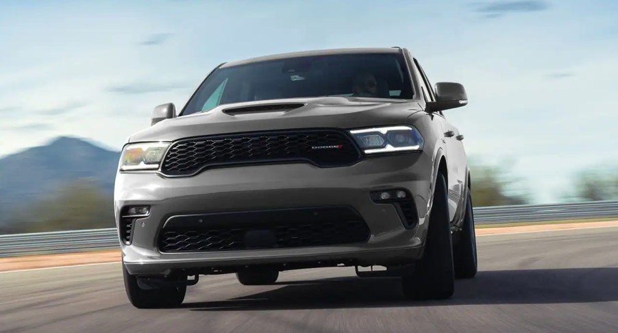 A gray 2022 Dodge Durango SUV is driving on the road.