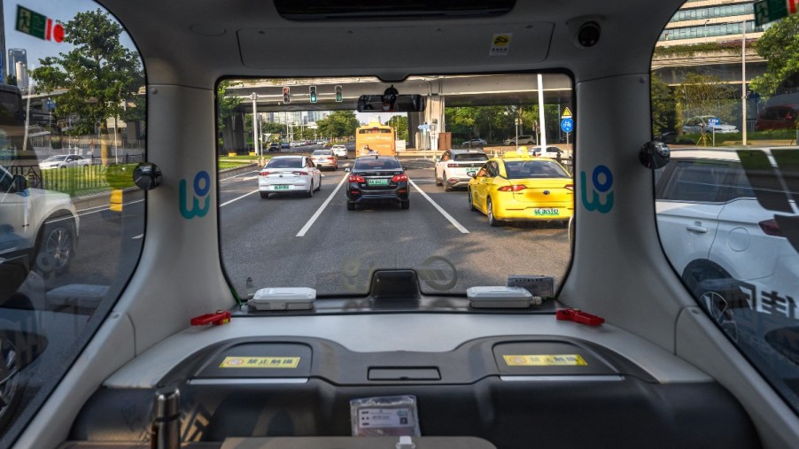 a driverless bus on a busy road, a future of city transportation