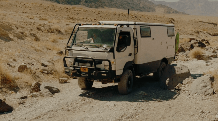 EarthCruiser Adventure action shot of a rig plowing through the sand