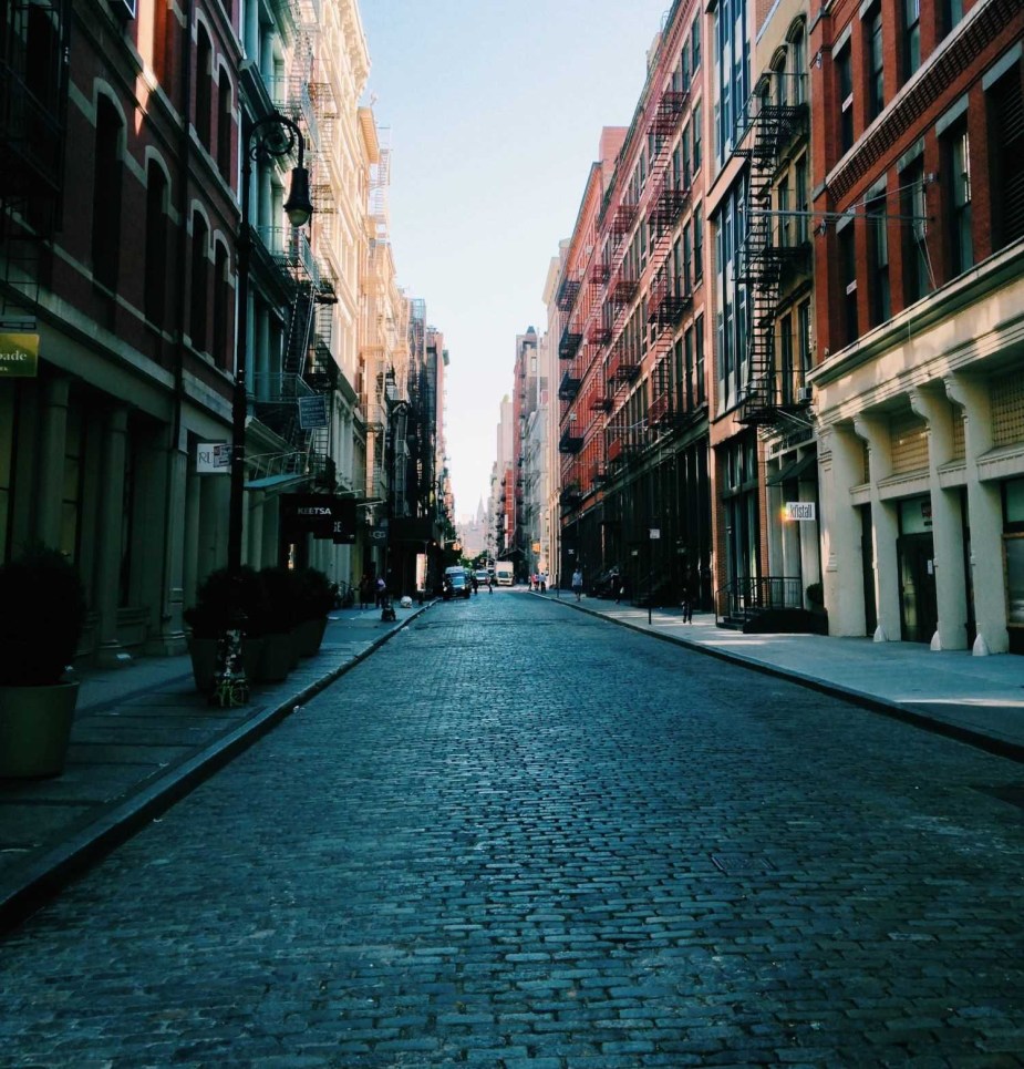 Empty cobblestone street, highlighting whether or not cars should be banned in cities