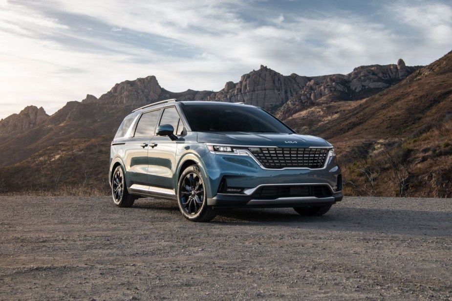 Front angle view of blue 2023 Kia Carnival minivan