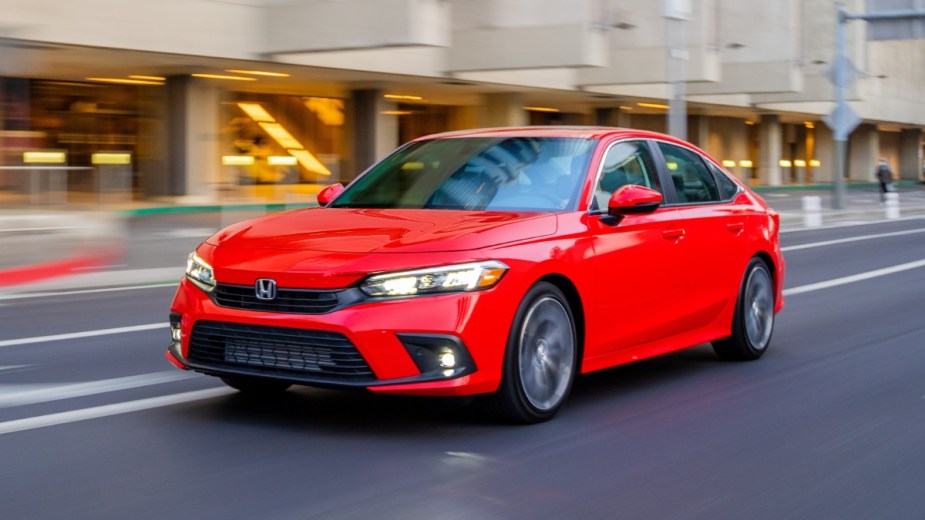 Front angle view of orange-red 2023 Honda Civic