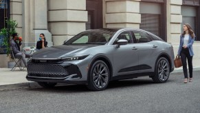 Front angle view of silver 2023 Toyota Crown SUV-like sedan, highlighting its release date and price