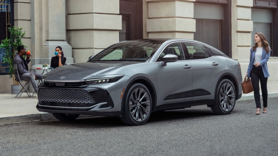 Front angle view of silver 2023 Toyota Crown SUV-like sedan, highlighting its release date and price