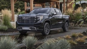 GMC Sierra 1500 Denali Ultimate sitting next to a home