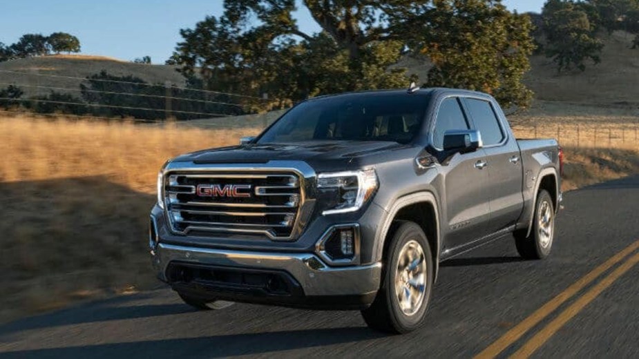 A GMC Sierra 1500 in Gray next to a field