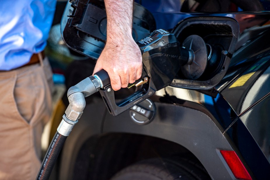 Car being filled with gas where you can pump your own gas. 