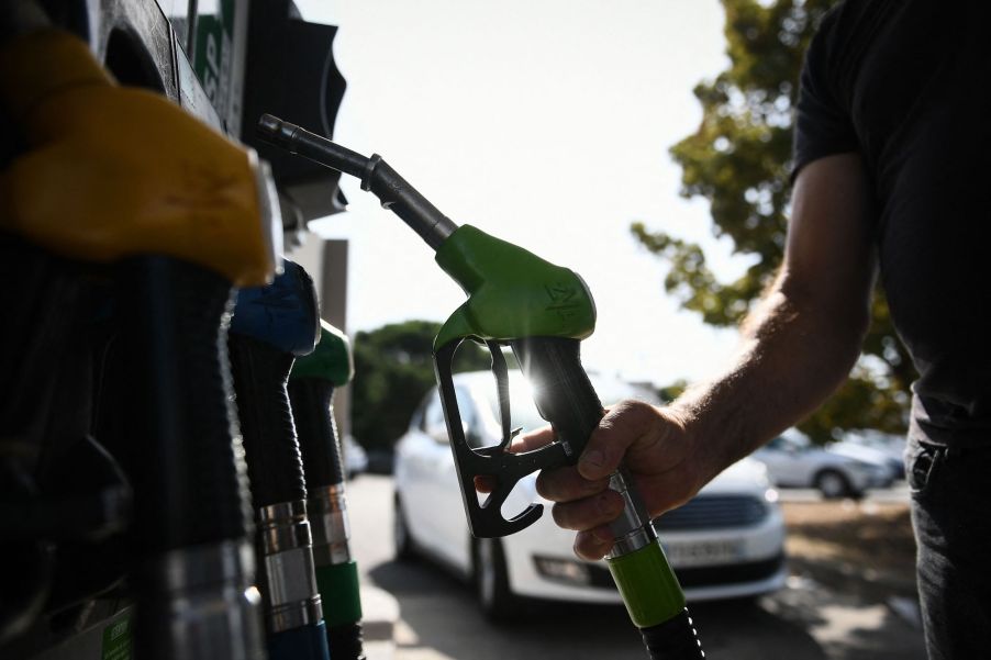 A person pumping more gas.