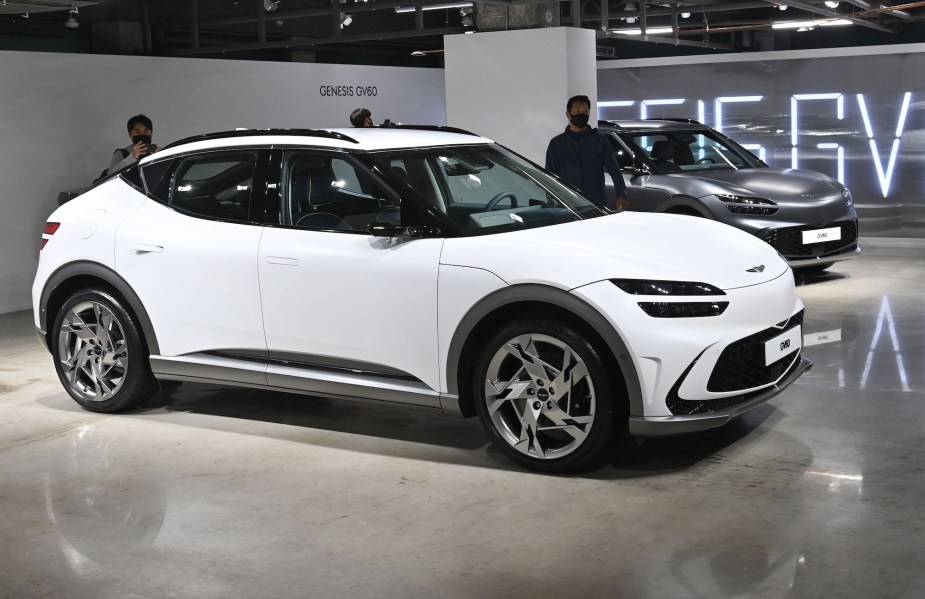 A white Genesis GV60 parked indoors. 