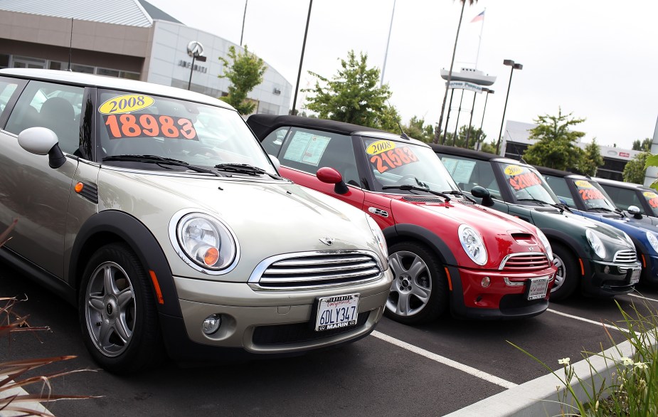 Used cars are displayed on a sales lot. 