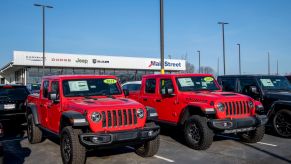 Car dealership lot displaying new 2021 vehicles on the lot.