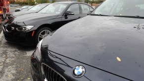 A person with hail damage on their car that hopes that hail damage is covered under their insurance.