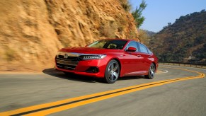 The Honda Accord, like this red one, has a spot on the list of mid-size cars that cost the least to own.