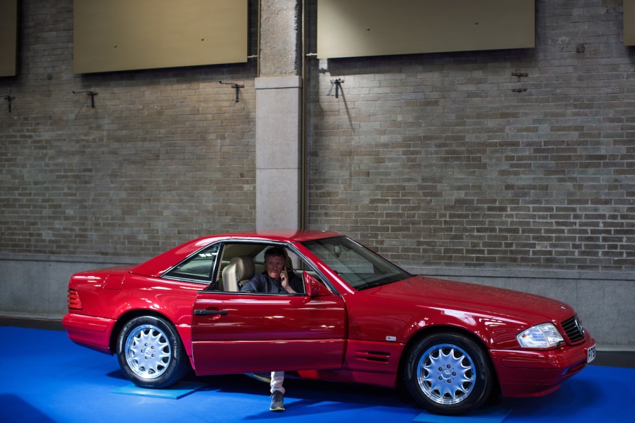 A man sits in a 1996 Mercedes Benz SL500