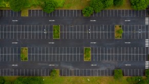 An empty parking lot with multiple parking spots where people could save your parking spot.