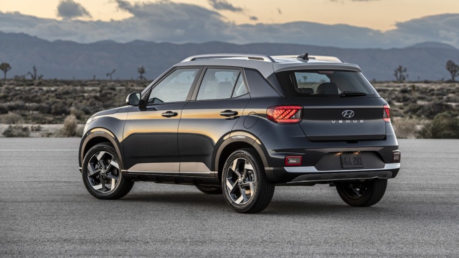 Rear angle view of dark gray 2023 Hyundai Venue crossover SUV, highlighting its release date and price