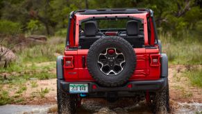 Rear view of red 2023 Jeep Wrangler 4xe, highlighting its release date and price