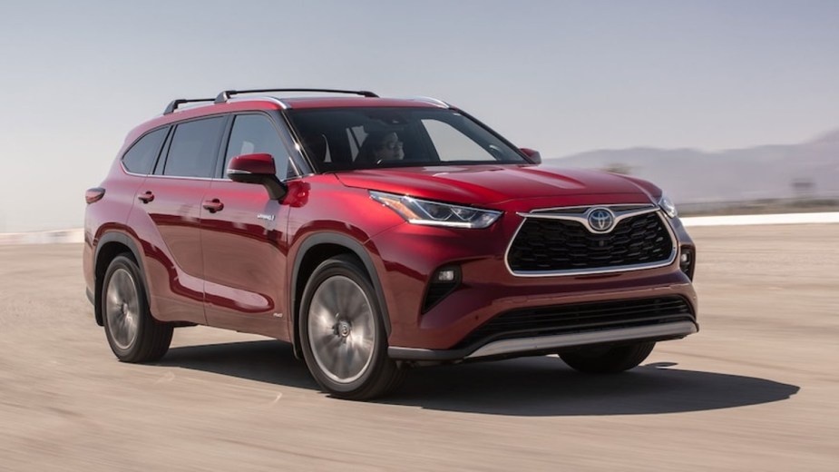 Red Toyota Highlander SUV on a dirt road