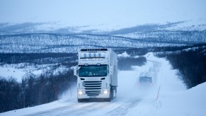 A semi-truck driving on a highway.