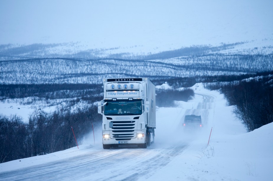 A semi-truck driving on a highway. 