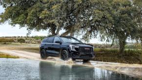 A black 2022 GMC Terrain driving. Is the SLE or SLT trim better?