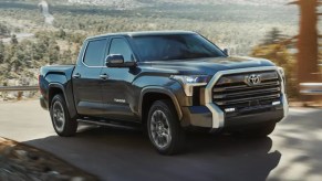 A black 2022 Toyota Tundra is driving on the road.