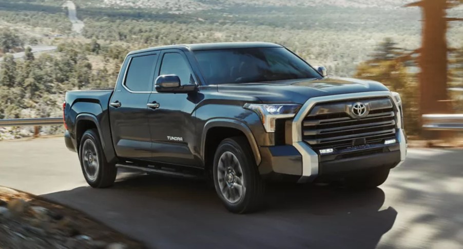 A black 2022 Toyota Tundra is driving on the road.